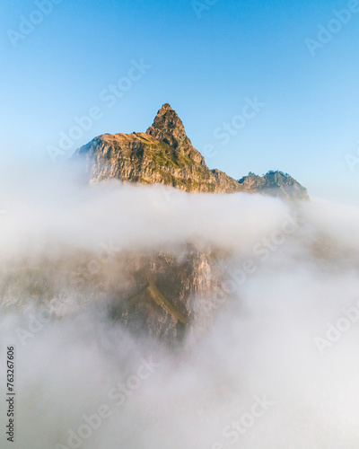 Aerial drone view of mountain peaks in morning light covered by clouds, Santo Antao island, Cape Verde. photo