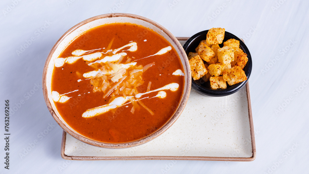 Tomato soup with crackers isolated on white Tomato soup with crackers isolated on white