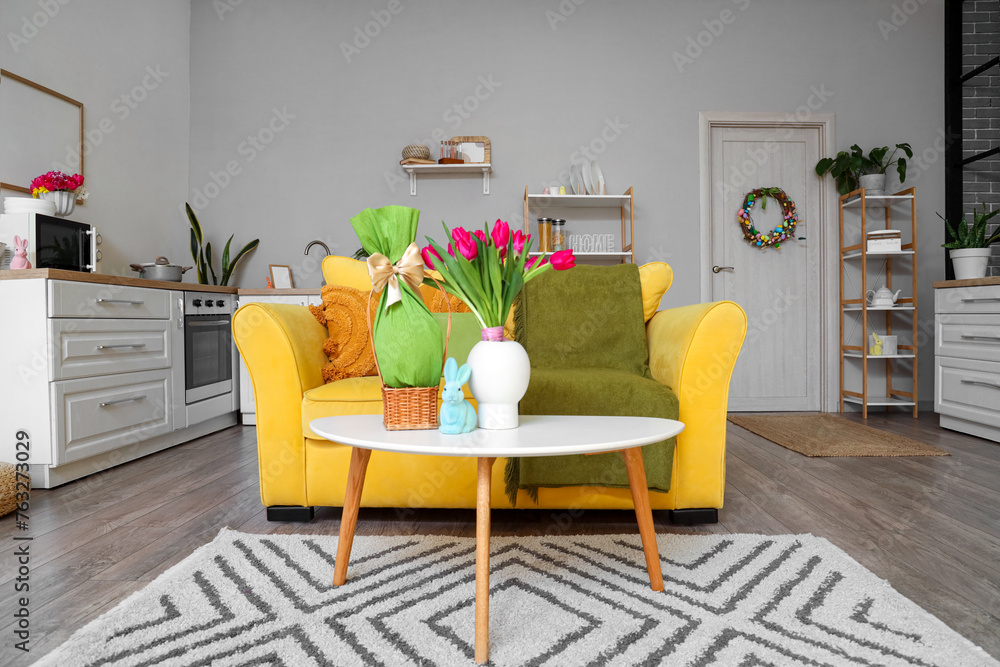 Obraz premium Interior of kitchen decorated for Easter with sofa, door and counters