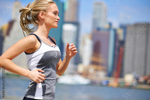 Fototapeta Naklejka Na Ścianę i Meble -  Woman, strong and running for fitness in city, jogging active and fit female person exercising in New York. Energy, marathon for sports training and workout for athlete, cardio for endurance