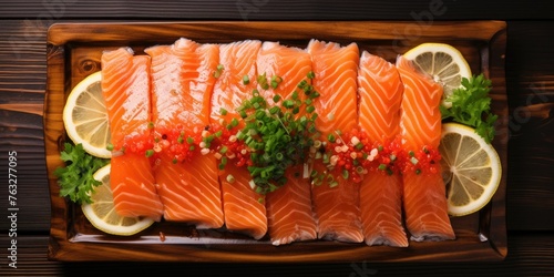 Salmon sashimi served with funchosa, lemon and soy sauce on wooden table, top view