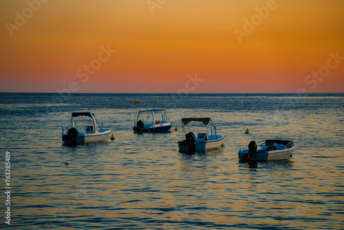 Many boats at sunset in the bay.