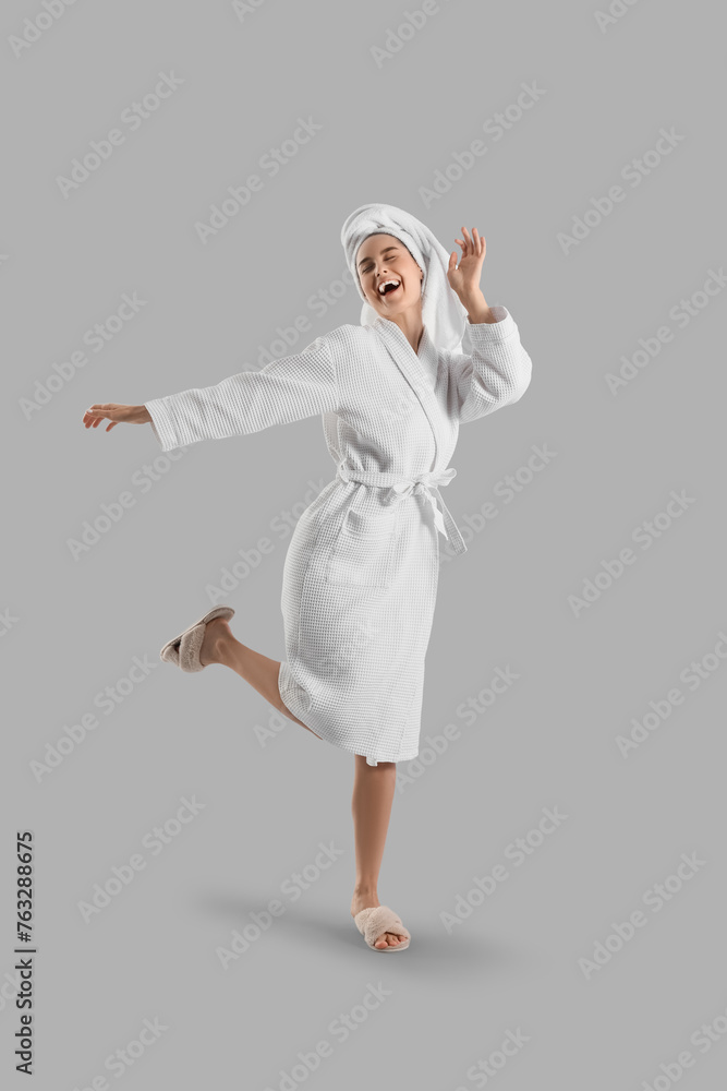 Young woman in bathrobe with towel after shower on light background Young woman in bathrobe with towel after shower on light background