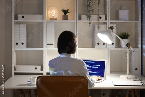 Female programmer coding la...