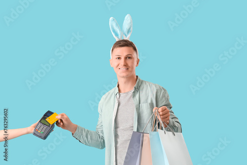 Young man in bunny ears wit...