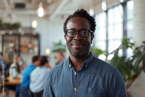 An affable African American executive in a vibrant coworking environment
