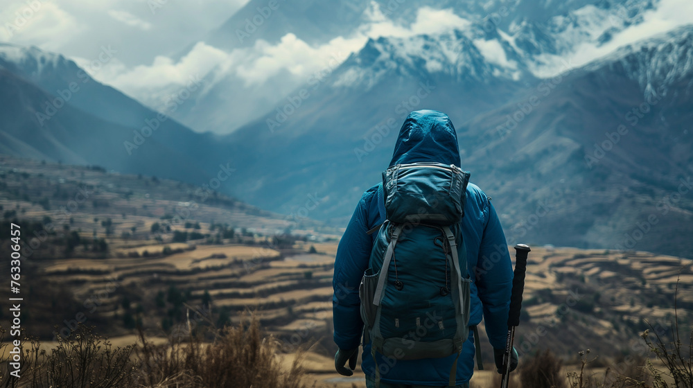 Explorer Facing Snowcapped Mountains and Terraced Fields Explorer Facing Snowcapped Mountains and Terraced Fields