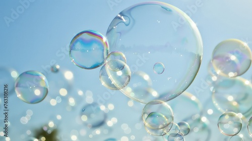 A lot small soap bubbles floating on clean blue sky background.