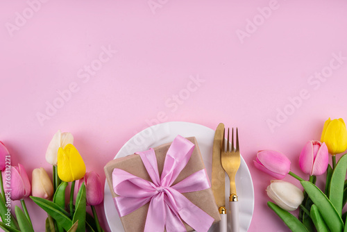 Mother day table setting background. Pink Mother s day border flat lay for brunch  lunch  dinner menu  invitation mockup. Beautiful table setting with golden cutlery  plate  tulip flowers and gift box