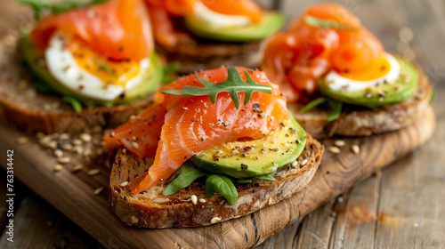 Close-up of healthy toast with avocado, salmon, egg, ideal for culinary themes. photo