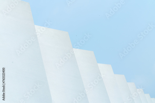 abstract white shape with empty blue sky for copy space.