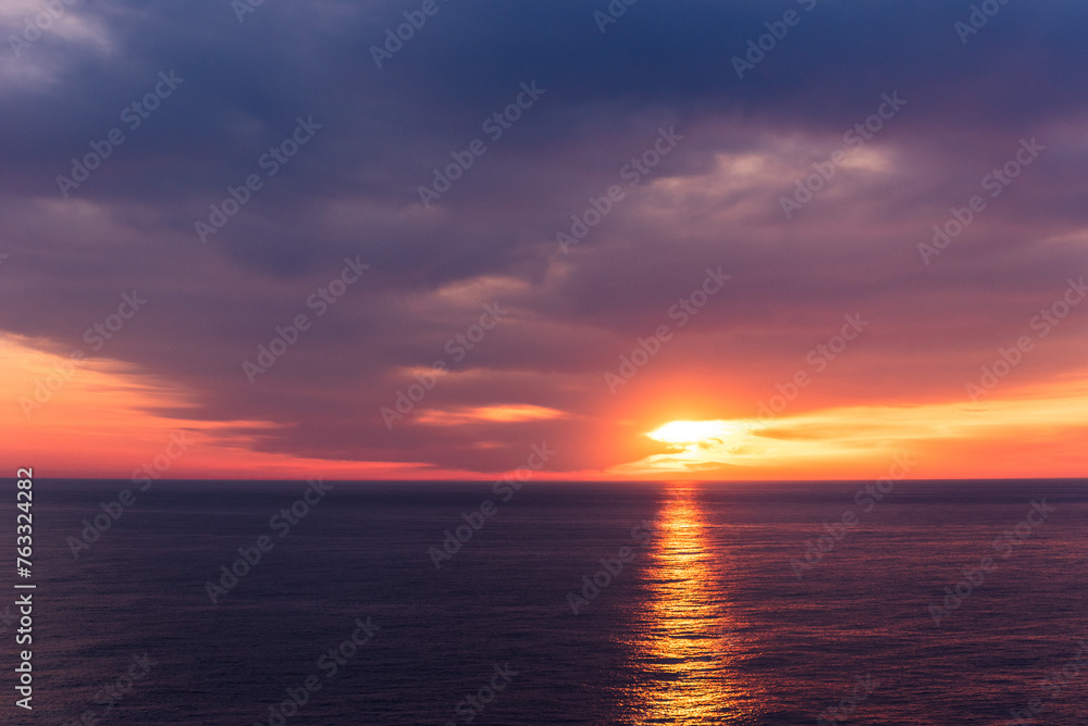 Beautiful sunset sky over the calm ocean.