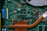 Electronic components on a computer graphics card. Bitcoin Cryptocurrency coin on a PC computer motherboard, cryptocurrency mining concept