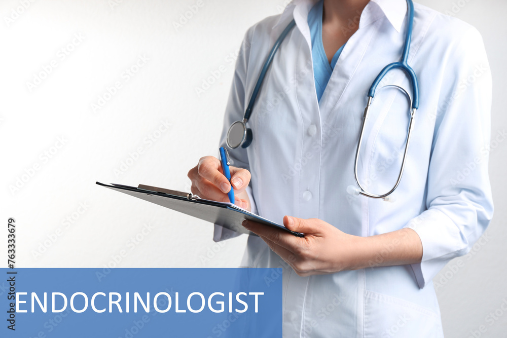 Endocrinologist with stethoscope, clipboard and pen on white background, closeup Endocrinologist with stethoscope, clipboard and pen on white background, closeup