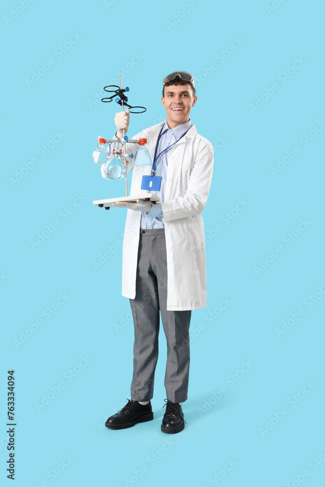 Male chemist with flasks on blue background Male chemist with flasks on blue background