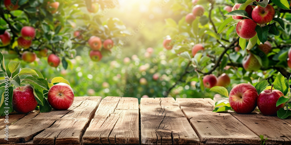 Empty wooden kitchen table over apple fruit garden background Empty wooden kitchen table over apple fruit garden background