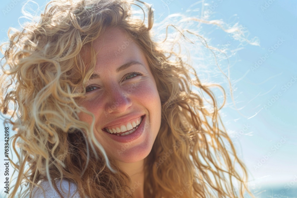 Beautiful woman with long hair smiling on the beach Beautiful woman with long hair smiling on the beach