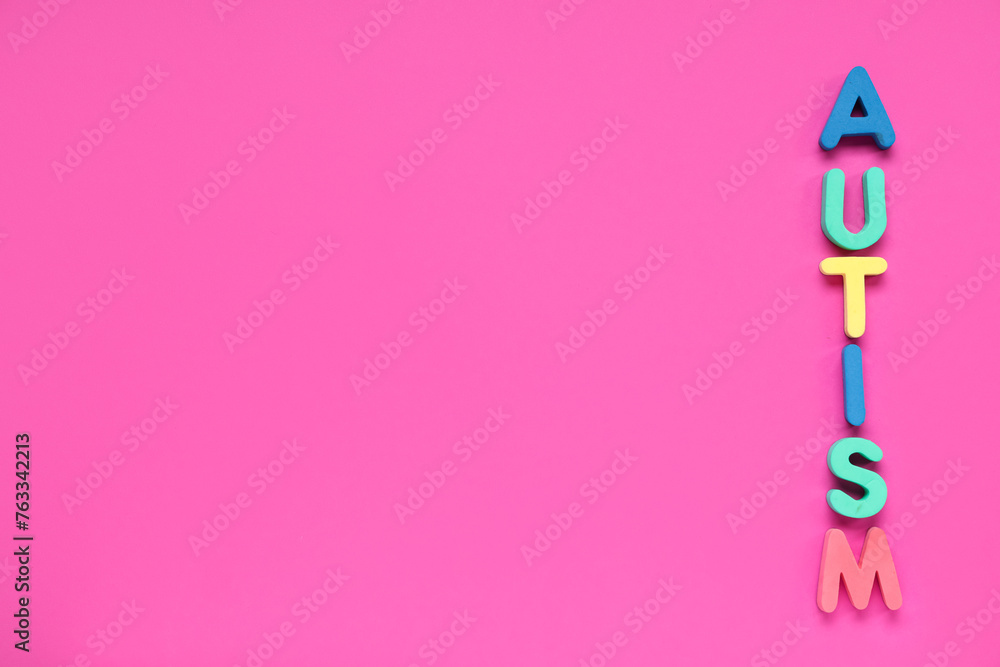 Word AUTISM on pink background. Autism disorder concept