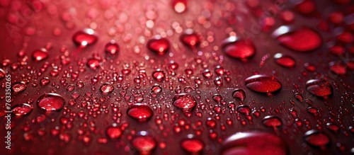 Close-up of water drops on a vibrant red surface  reflecting light and creating a unique pattern  enhancing the surface texture