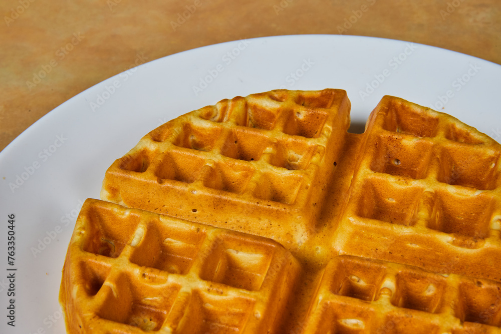 Golden Brown Waffle on White Plate - Close-Up Breakfast Texture Golden Brown Waffle on White Plate - Close-Up Breakfast Texture
