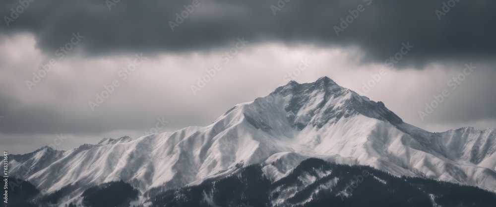 Mountain covered in snow under a cloudy sky