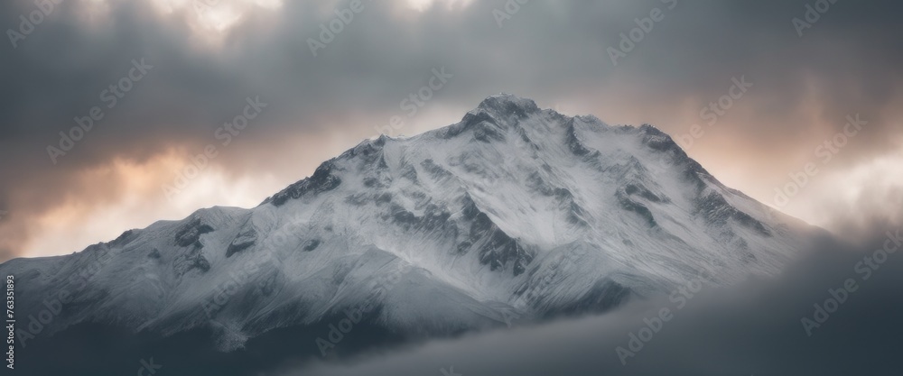 Mountain covered in snow under a cloudy sky