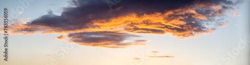 Fototapeta Naklejka Na Ścianę i Meble -  Dawn-lit clouds in warm hues, ideal for vibrant backgrounds