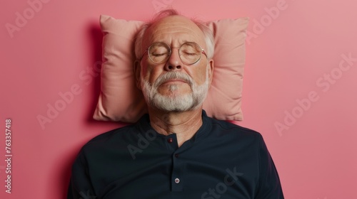 Elderly man sleeping on pillow isolated on pastel pink colored background Sleep deeply peacefully rest. Top above high angle view photo portrait of satisfied .senior wear black shirt