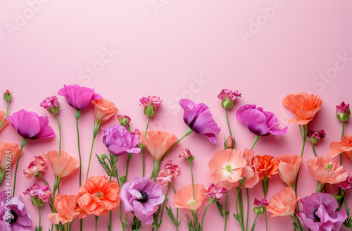 Beautiful spring flowers arrangement on pink background with copy space, flat lay, top view concept for greetings card