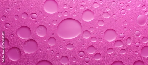 Water droplets on pink surface
