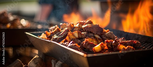 Beef grilling over flames a...