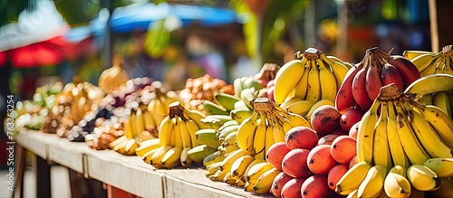 Various bananas and peaches at market stall photo
