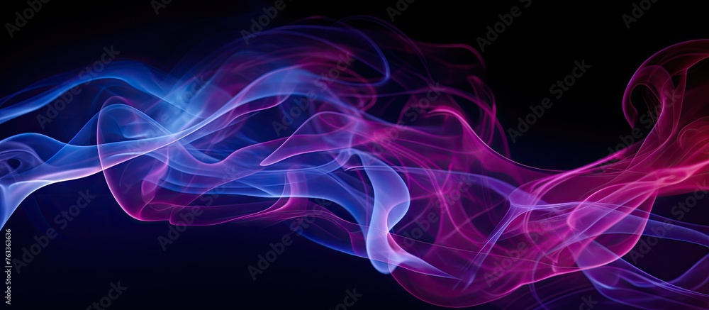 Blue and pink smoke swirl close-up on black backdrop