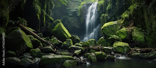 Waterfall streaming through forest with rocks and trees