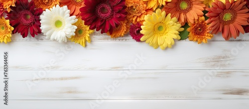 Autumn flowers on white woo...