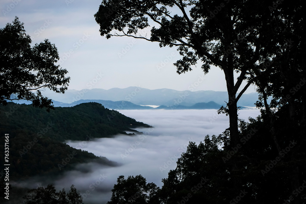 Morning view of clouds in the Reems Creek valley and a distant view of the Blue Ridge Mountains; Weaverville, North Carolina, United States of America Morning view of clouds in the Reems Creek valley and a distant view of the Blue Ridge Mountains; Weaverville, North Carolina, United States of America