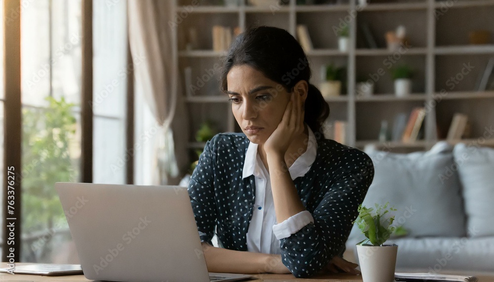 Young woman looking at laptop screen in despair, unemployed female looking through job hunting sites unsuccessfully, frustrated female freelancer fails Young woman looking at laptop screen in despair, unemployed female looking through job hunting sites unsuccessfully, frustrated female freelancer fails