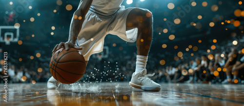 Basketball player is holding basketball ball on a court, close up photo photo