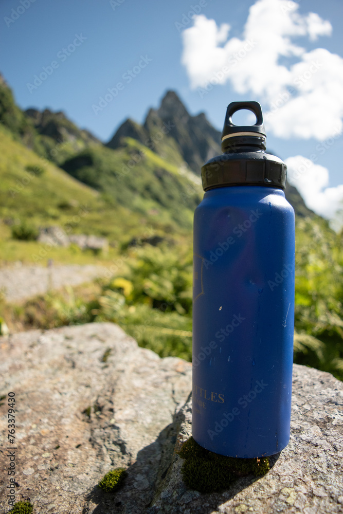 Sustainable Blue Water Bottle in Alpine Mountain Setting Sustainable Blue Water Bottle in Alpine Mountain Setting