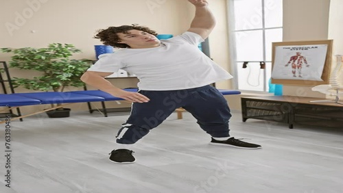 Hispanic man performing physical therapy exercises in a rehab clinic's room, showcasing balance and flexibility. photo