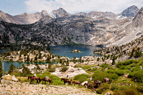 Horses and riders lead a string of pack animals near Sixty Lake Basin in King's Canyon National Park, California, USA; California, United States of America photo