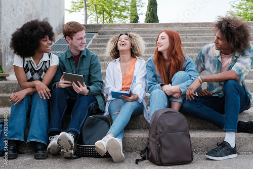 Group of students resting together in the faculty. Concept: outdoors, friendship