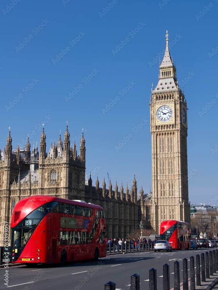 Obraz premium golden big ben clock London England Parliament red buses on bridge blue sky 