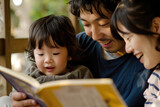 A young Japanese family reading a book together
