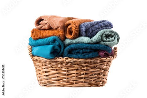 Clothes and towel in laundry wicker basket isolated on transparent background.