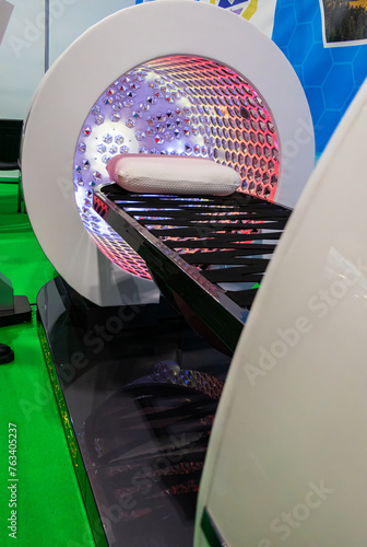 Vertical solarium in the shape of a futuristic capsule chair with LED lighting inside