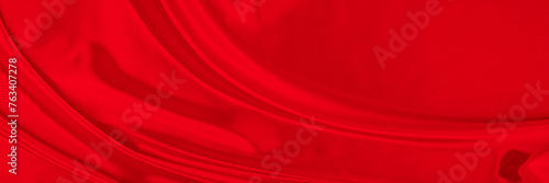 Black red satin dark fabric texture luxurious shiny that is abstract silk cloth background with patterns soft waves blur beautiful.