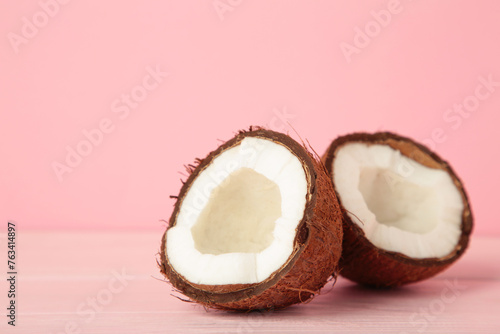Coconut with half on pink background. Space for text