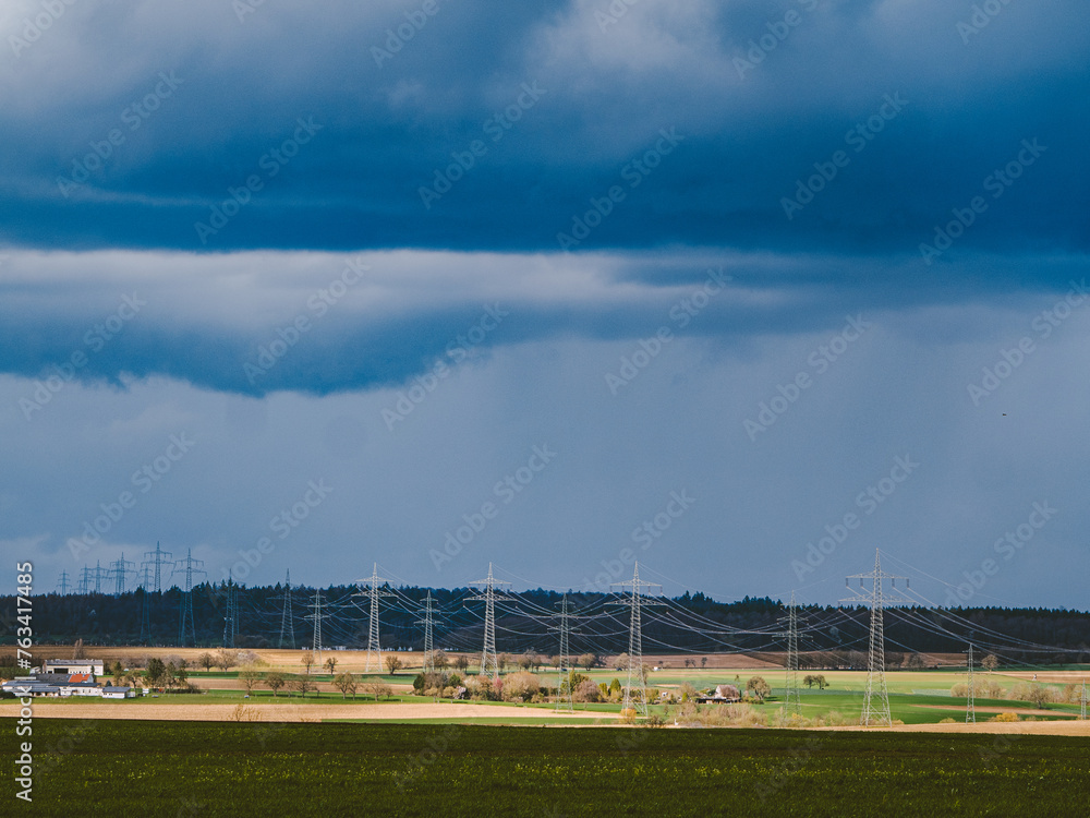 Strommasten einer Überlandleitung und dunkler Wolkenhimmel Strommasten einer Überlandleitung und dunkler Wolkenhimmel
