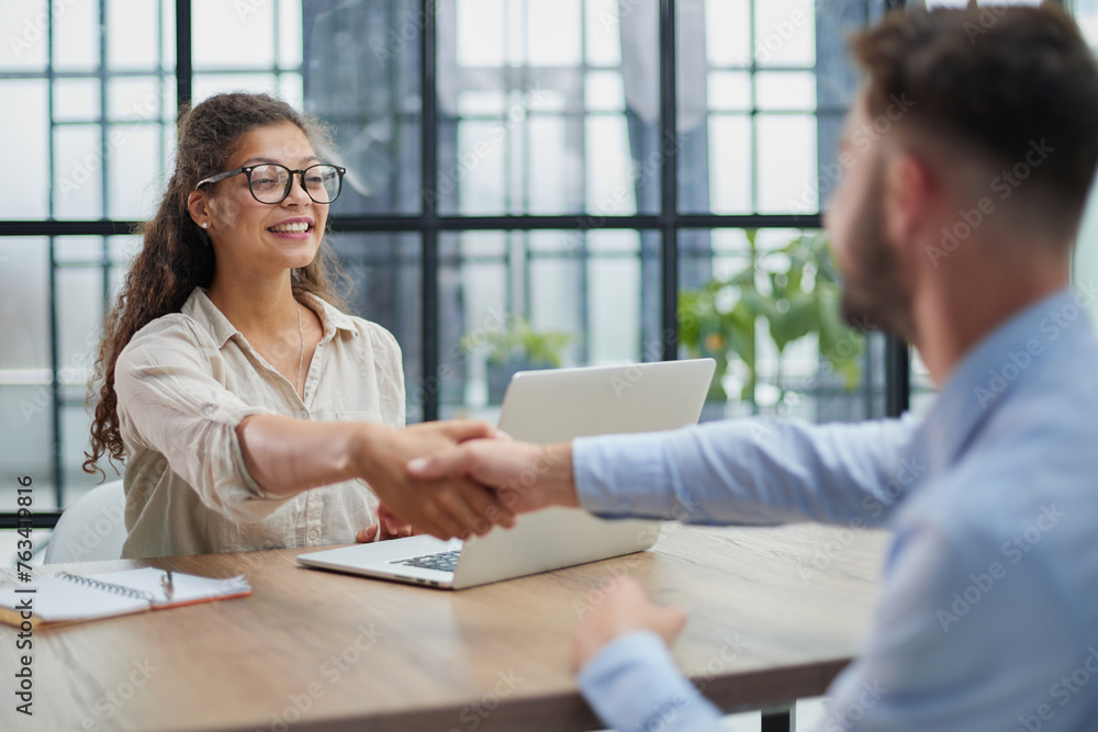 Fototapeta premium Handshake of business people sitting at the table in the office